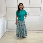 Emerald green bamboo, relaxed fit, scoop neckline , short sleeve, summer top, with band on hem for shape. Worn with long green patterned long, maxi skirt.