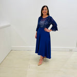 Royal blue,full circle skirt, with dipped hemline at back, wide flat waistband, with zipper opening and side seam pockets. Blue embroidered silk chiffon, round neckline, ruffle sleeve, relaxed fit women's blouse.