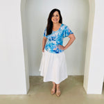 Blue floral, round neckline, short wave sleeve top with white skirt.