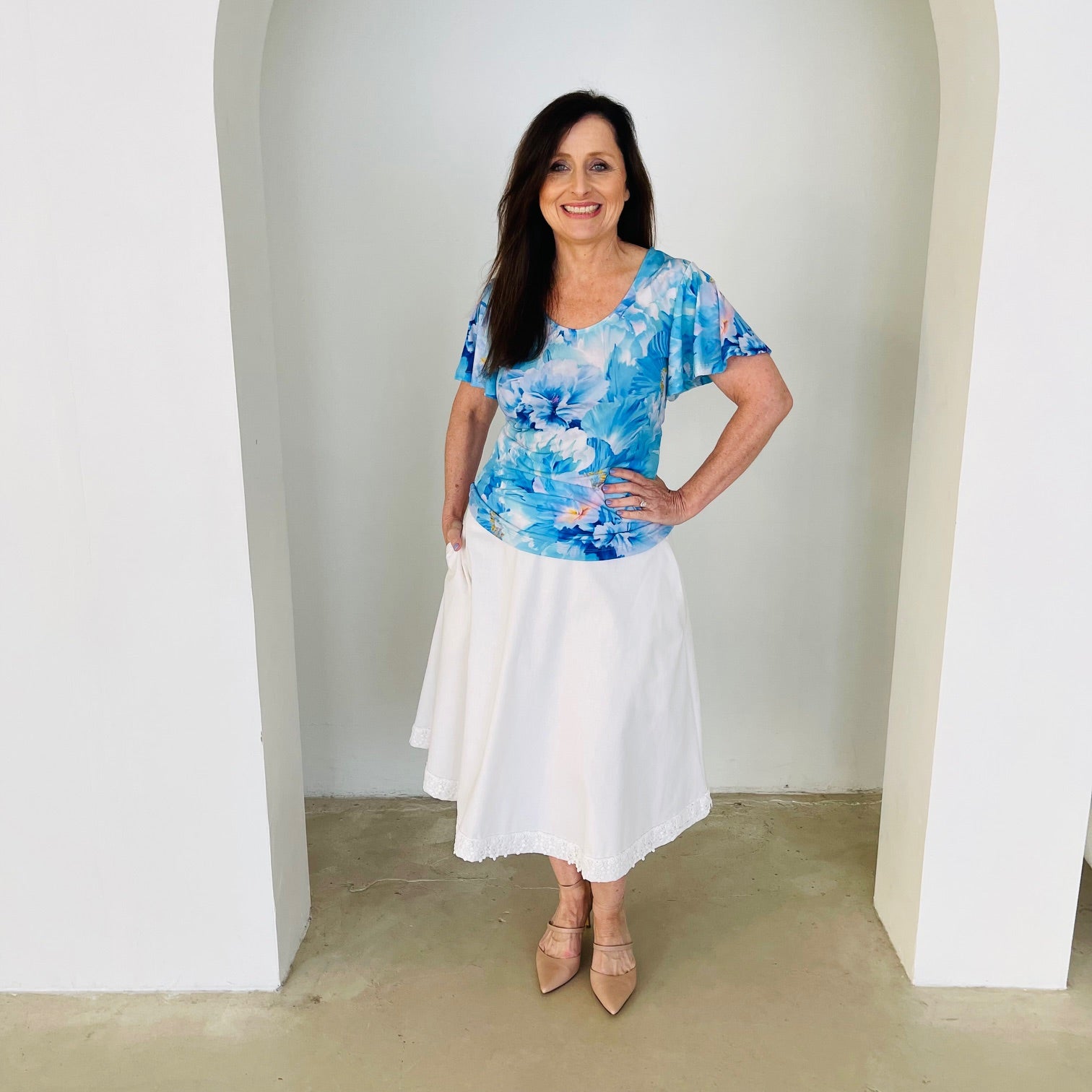 Blue floral, round neckline, short wave sleeve top with white skirt.