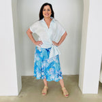 Women's pale blue linen shirt with side tie, worn with midi length, blue floral ,skirt