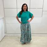 Emerald green bamboo, relaxed fit, scoop neckline , short sleeve, summer top, with band on hem for shape. Worn with long green patterned long, maxi skirt.