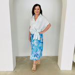 Women's pale blue linen shirt with side tie, worn with midi length, blue floral ,skirt