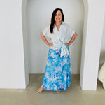 Women's pale blue linen shirt with side tie, worn with long, maxi,  length, blue floral ,skirt