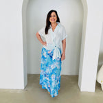Women's pale blue linen shirt with side tie, worn with long, maxi,  length, blue floral ,skirt