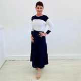 Navy Linen Tiered 7/8s length Skirt. White Bamboo long sleeve top with navy neckline and cuff detail.