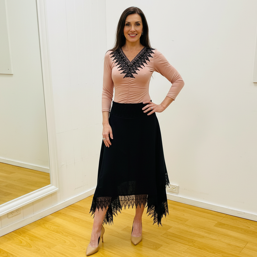 Black linen skirt, with lace detail on waistband and around the handkerchief, uneven, hemline. With pale pink, black lace v neckline detail top.