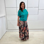 Emerald green bamboo, relaxed fit, scoop neckline , short sleeve, summer top, with band on hem for shape. Worn with long maxi skirt in Aztec print fabric.