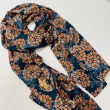 Navy background with a frangipani print chiffon scarf