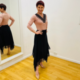 Black linen skirt, with lace detail on waistband and around the handkerchief, uneven, hemline. With pale pink, black lace v neckline detail top.