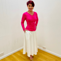 Hot pink, bright pink, bamboo, long sleeved, v neckline, ruched front top, with white, midi length, a line skirt with pockets.