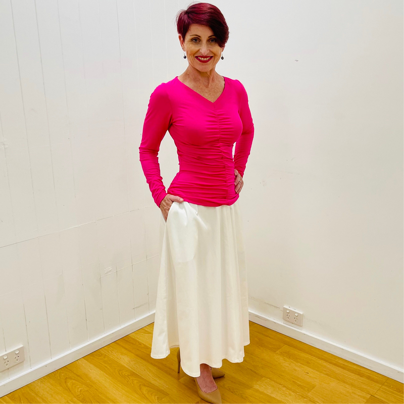 Hot pink, bright pink, bamboo, long sleeved, v neckline, ruched front top, with white, midi length, a line skirt with pockets.