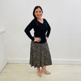 Black, cream,beige coloured printed, midi length, skirt with stretch waistband. Black bamboo, v neckline, gathered front, long sleeve, fitted women's top.