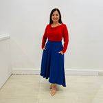 Royal blue,full circle skirt, with dipped hemline at back, wide flat waistband, with zipper opening and side seam pockets. Red bamboo, cowl neckline, long sleeve, semi fitted women's top.