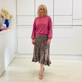 Relaxed, loose line fit top, long sleeve,with wrist cuff, round neck, waistband for shape. With soft drape midi length, brown floral skirt with soft ruffle on asymmetrical hemline.