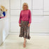 Relaxed, loose line fit top, long sleeve,with wrist cuff, round neck, waistband for shape. With soft drape midi length, brown floral skirt with soft ruffle on asymmetrical hemline.