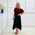 Black & red floral print, off the shoulder, asymmetrical neckline, relaxed fit top, worn with black, handkerchief hemline skirt with elastic waistband.