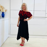 Black & red floral print, off the shoulder, asymmetrical neckline, relaxed fit top, worn with black, handkerchief hemline skirt with elastic waistband.
