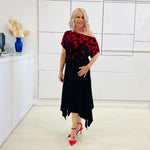 Black & red floral print, off the shoulder, asymmetrical neckline, relaxed fit top, worn with black, handkerchief hemline skirt with elastic waistband.