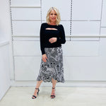 Noir garden-Black and white floral print, Rachel  Ruffle skirt, with elastic stretch waist. Worn on model with black bamboo , long sleeve, split front, Sabrina top. 