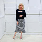 Noir garden-Black and white floral print, Rachel  Ruffle skirt, with elastic stretch waist. Worn on model with black bamboo , long sleeve, split front, Sabrina top. 