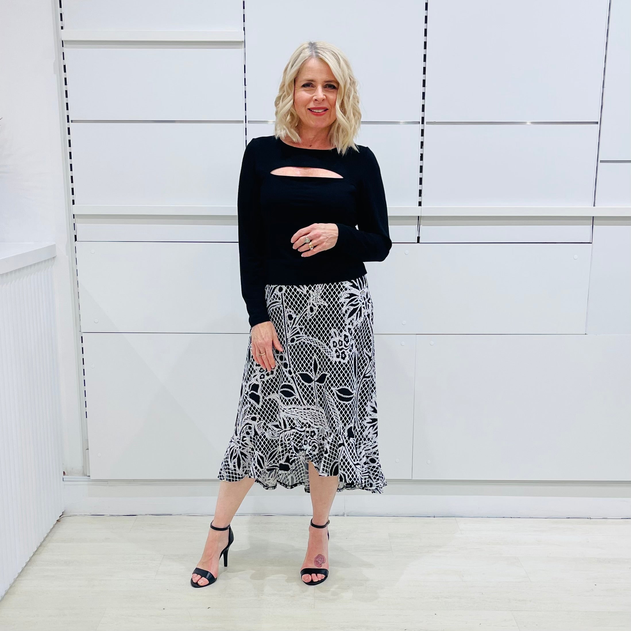 Noir garden-Black and white floral print, Rachel  Ruffle skirt, with elastic stretch waist. Worn on model with black bamboo , long sleeve, split front, Sabrina top. 