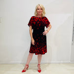 Black base colour dress with red floral border print on neckline and hemline. Short sleeve & knee length dress. 
