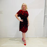 Black base colour dress with red floral border print on neckline and hemline. Short sleeve & knee length dress. 