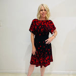 Black base colour dress with red floral border print on neckline and hemline. Short sleeve & knee length dress. 
