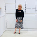 Noir garden-Black and white floral print, Rachel  Ruffle skirt, with elastic stretch waist. Worn on model with black bamboo , long sleeve, split front, Sabrina top. 