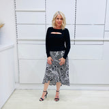 Noir garden-Black and white floral print, Rachel  Ruffle skirt, with elastic stretch waist. Worn on model with black bamboo , long sleeve, split front, Sabrina top. 