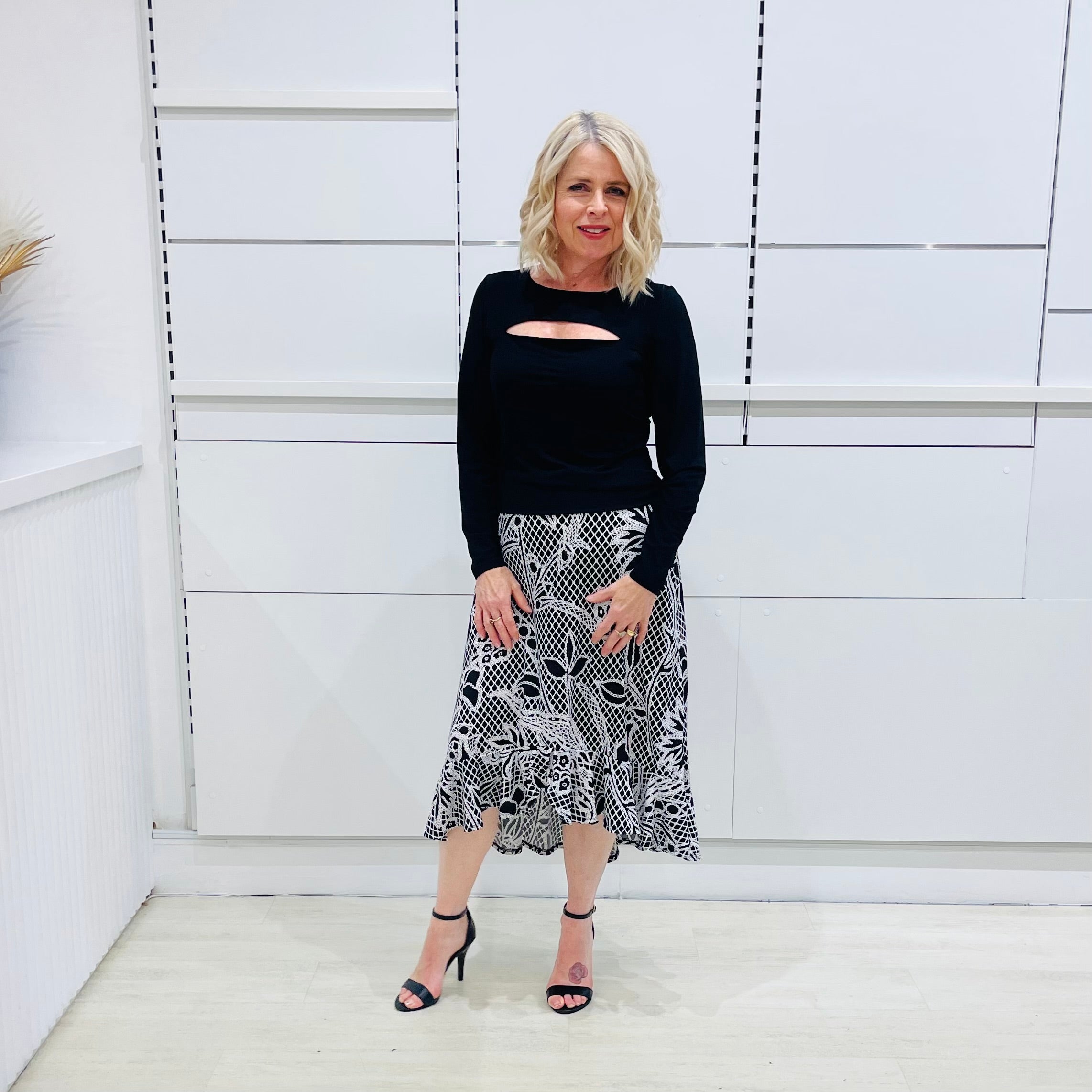 Noir garden-Black and white floral print, Rachel  Ruffle skirt, with elastic stretch waist. Worn on model with black bamboo , long sleeve, split front, Sabrina top. 