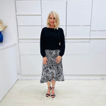 Noir garden-Black and white floral print, Rachel  Ruffle skirt, with elastic stretch waist. Worn on model with black bamboo , long sleeve,  round neckline, Gracie top.