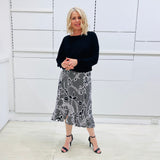 Noir garden-Black and white floral print, Rachel  Ruffle skirt, with elastic stretch waist. Worn on model with black bamboo , long sleeve,  round neckline, Gracie top.