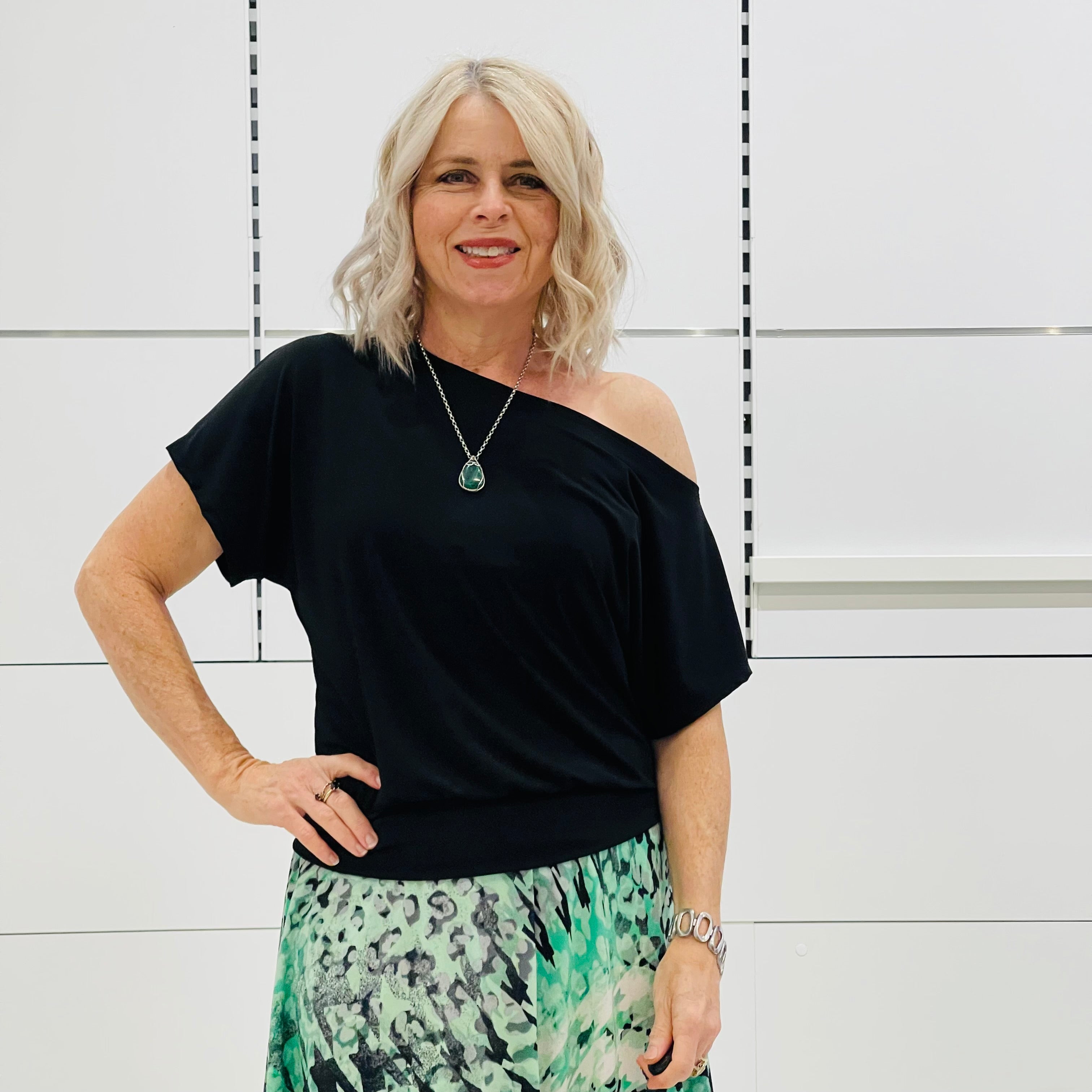 Relaxed fit, black ff the shoulder top with waist shape band. 