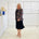 Black silk, with floral embroidery, collar, lapels, 3 button front closure, with pockets jacket. Worn with dressy straight black dress with side seam splits.