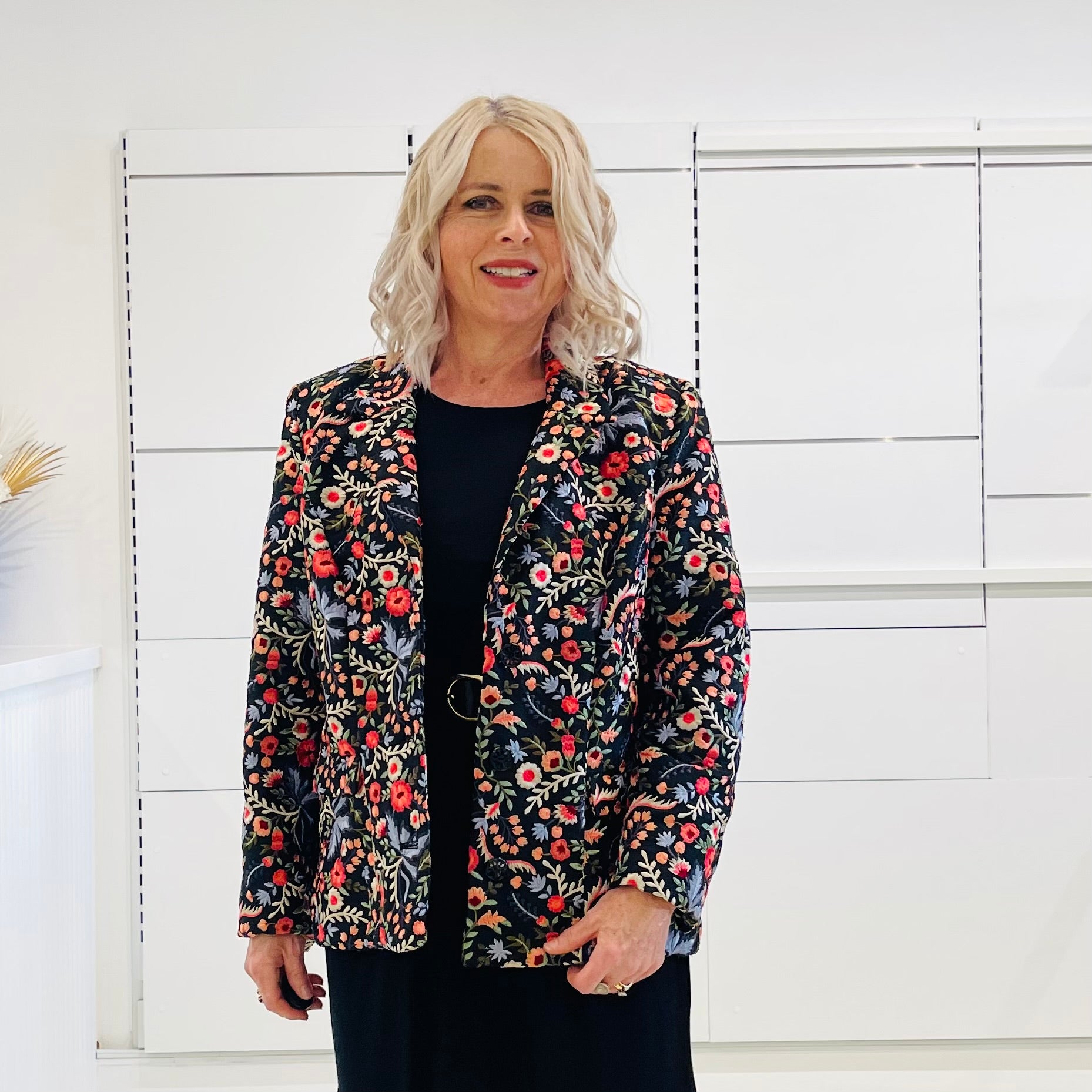 Black silk, with floral embroidery, collar, lapels, 3 button front closure, with pockets jacket. Worn with dressy straight black dress with side seam splits.