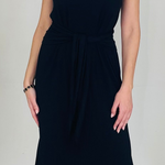 Black dress worn by a person on a plain background