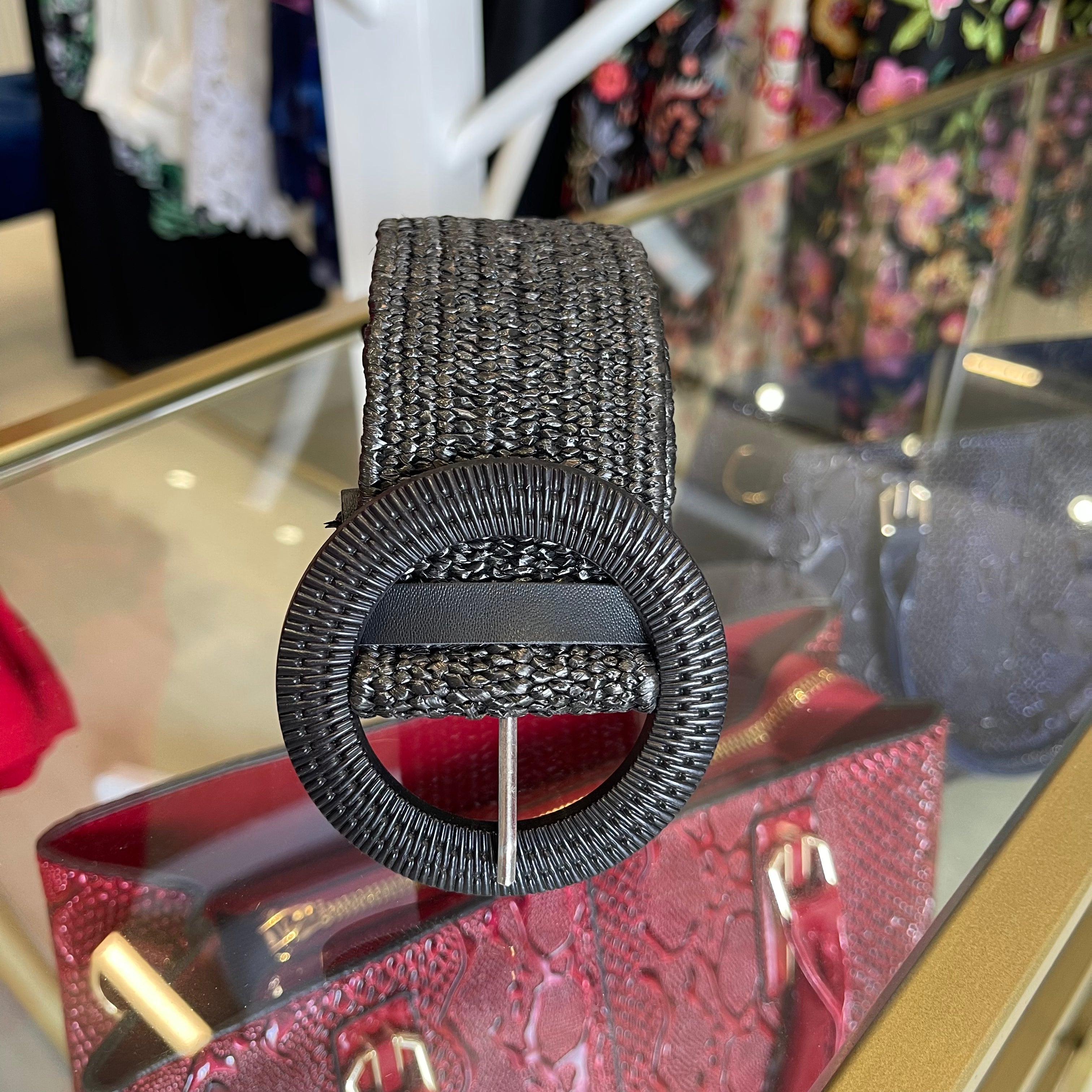 Black rattan, stretchy women's belt, 90 cm long, round buckle with silver coloured prong.