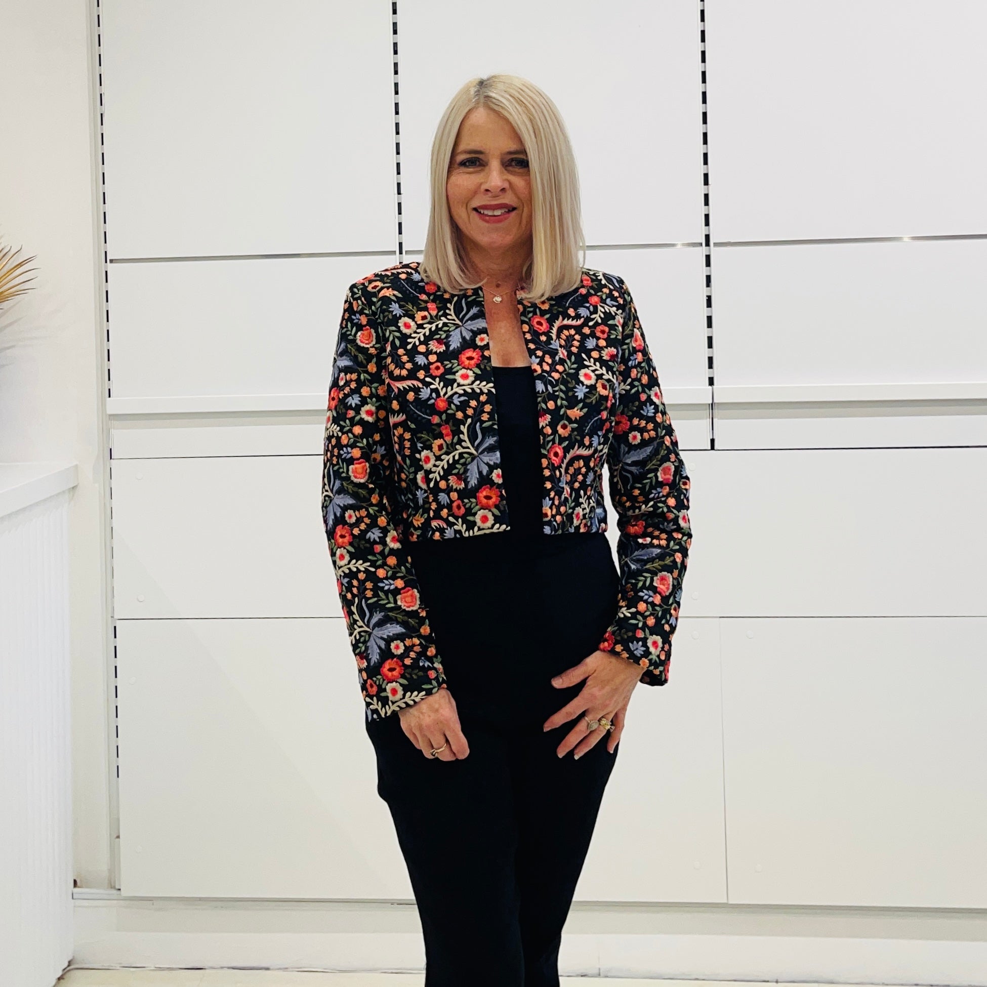 Black short, bolero jacket with all over multi coloured embroidery.