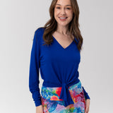Woman wearing blue bamboo top and colourful skirt