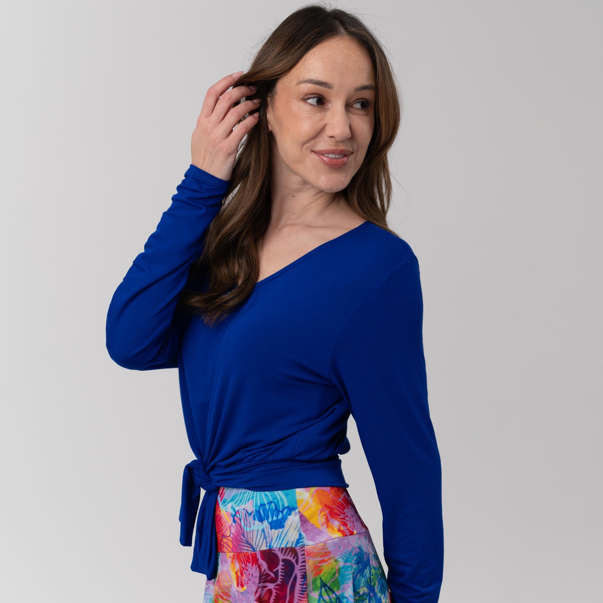 Woman wearing blue top and colourful skirt