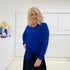 Relaxed fit, cobalt blue bamboo, v neckline, long sleeve, tie front detail, dressy top. Worn with midi length skirt with slight hemline ruffle in black.
