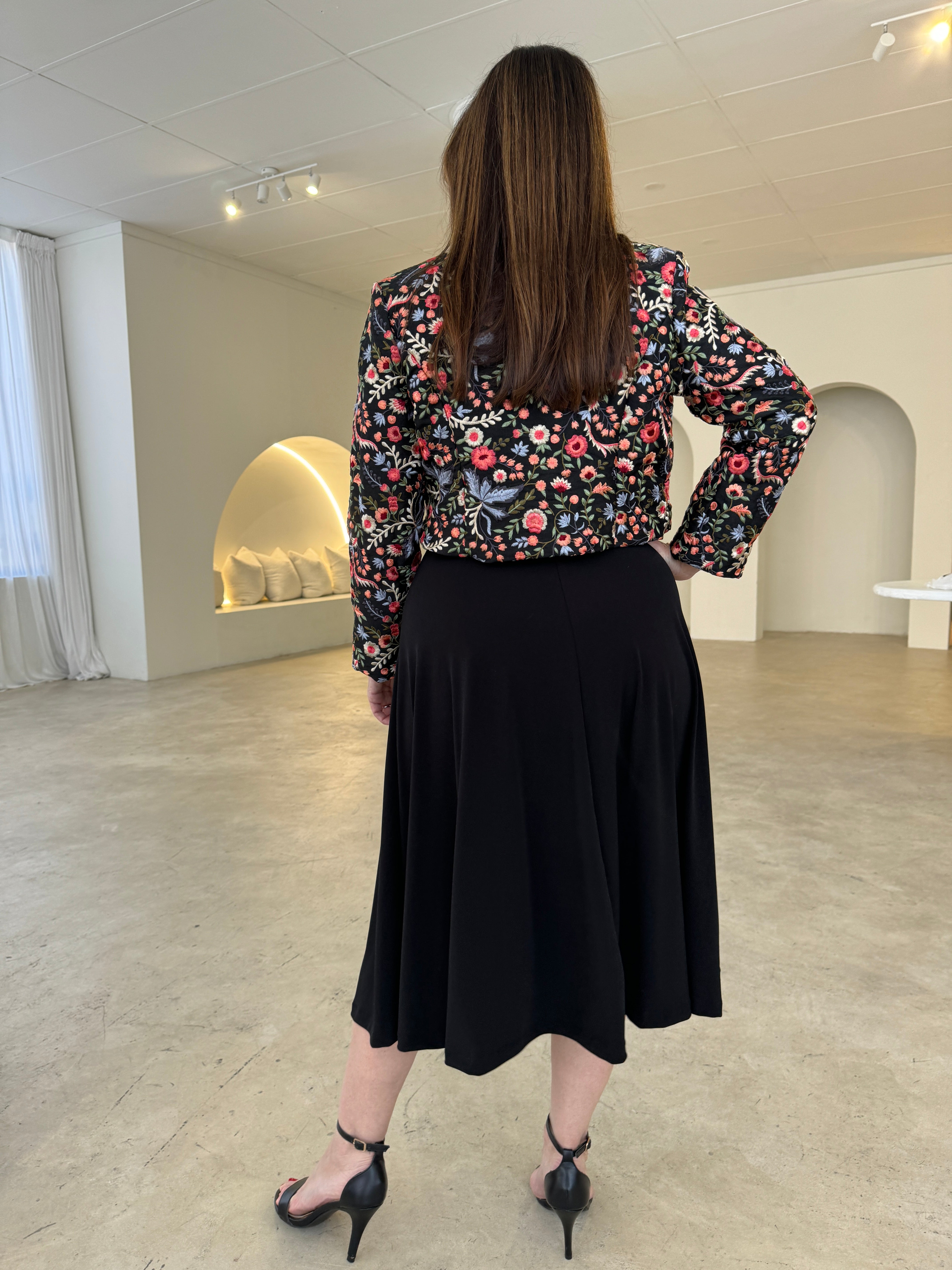 Black short, bolero jacket with all over multi coloured embroidery.With black dress.
