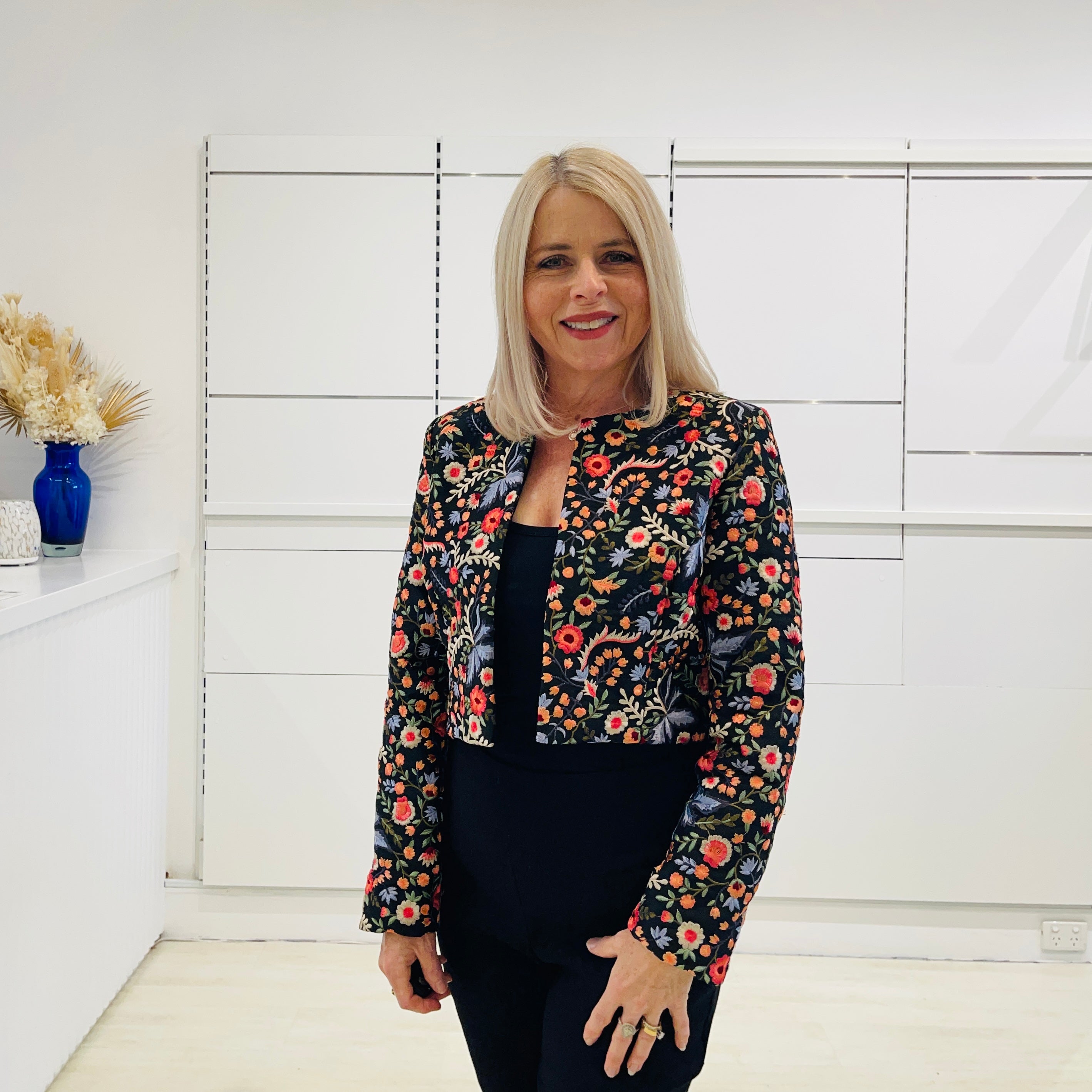 Black bolero, short jacket with all over multi coloured embroidery.