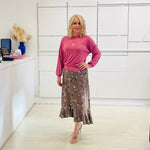 Relaxed, loose line fit top, long sleeve,with wrist cuff, round neck, waistband for shape. With soft drape midi length, brown floral skirt with soft ruffle on asymmetrical hemline.