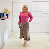 Relaxed, loose line fit top, long sleeve,with wrist cuff, round neck, waistband for shape. With soft drape midi length, brown floral skirt with soft ruffle on asymmetrical hemline.