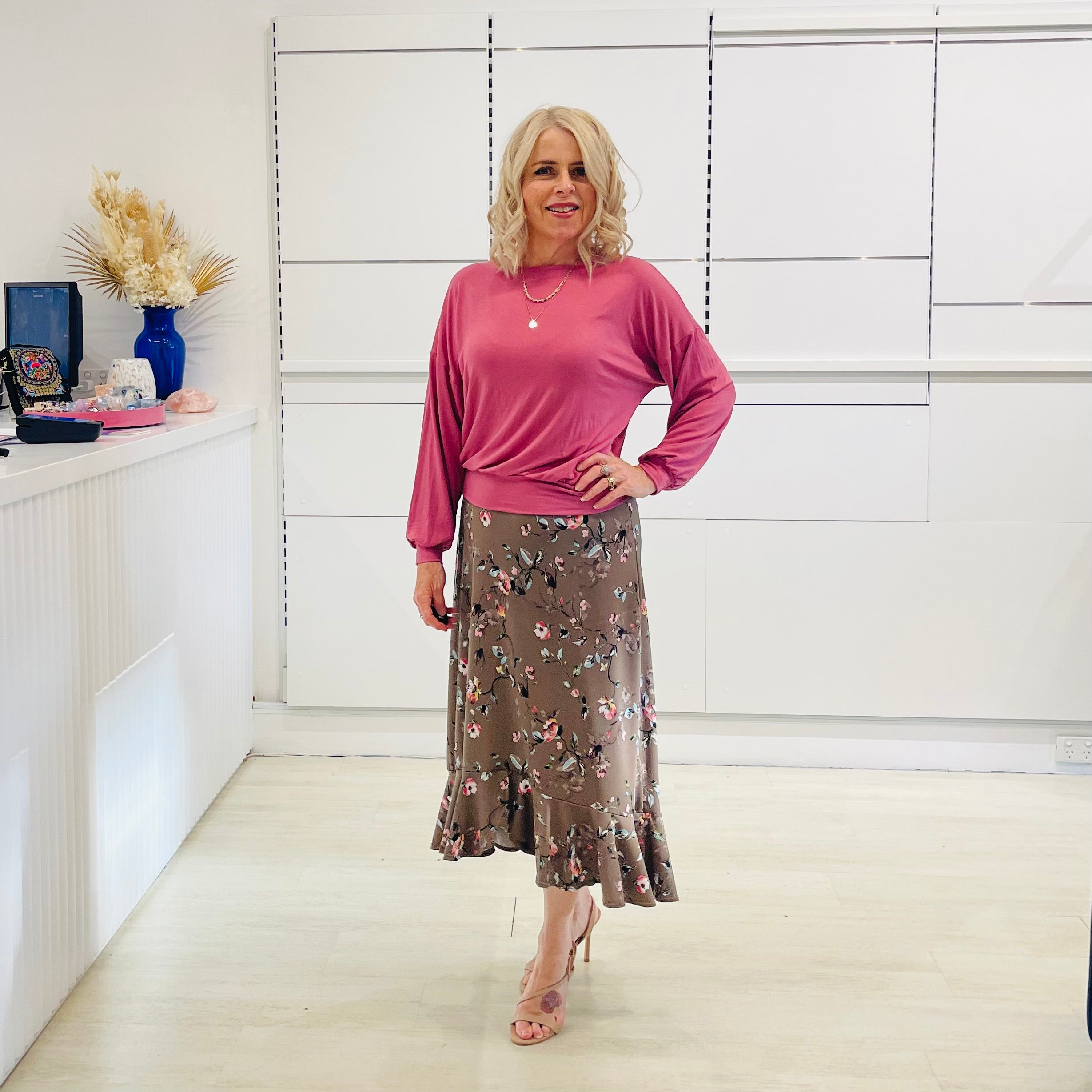 Relaxed, loose line fit top, long sleeve,with wrist cuff, round neck, waistband for shape. With soft drape midi length, brown floral skirt with soft ruffle on asymmetrical hemline.