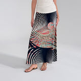 Person wearing a long, patterned skirt with a white top on a light gray background