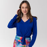 Woman in blue top and colourful skirt
